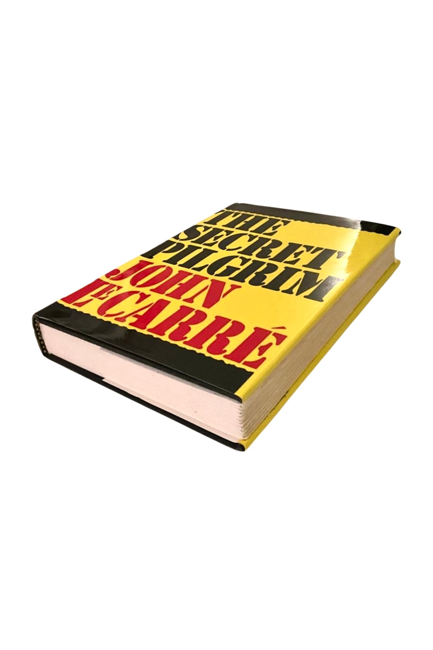 Book titled 'The Secret Pilgrim' by John F. Carr with a yellow and black cover on a white background, showing the front cover and edges