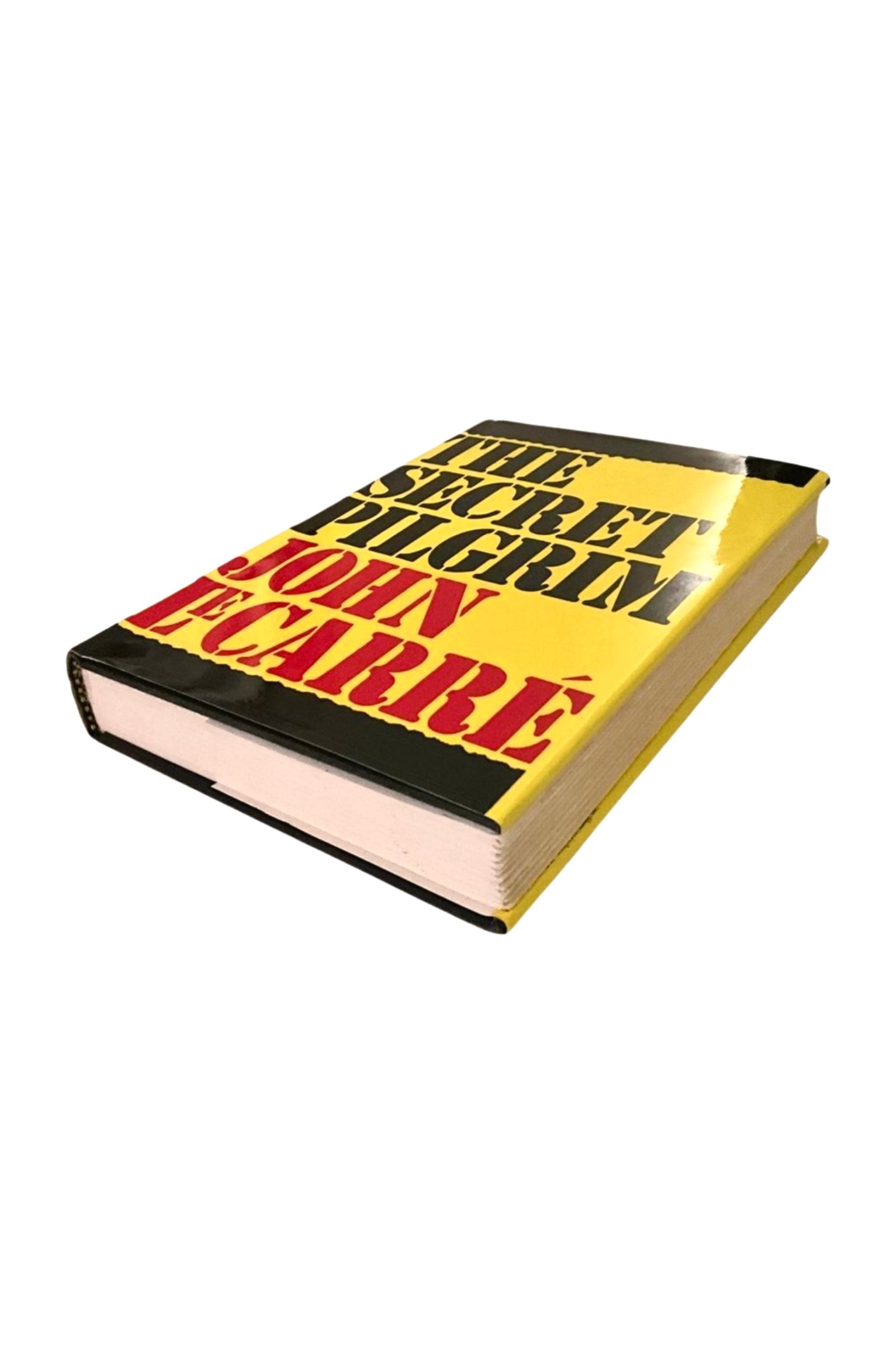 Book titled 'The Secret Pilgrim' by John F. Carr with a yellow and black cover on a white background, showing the front cover and edges