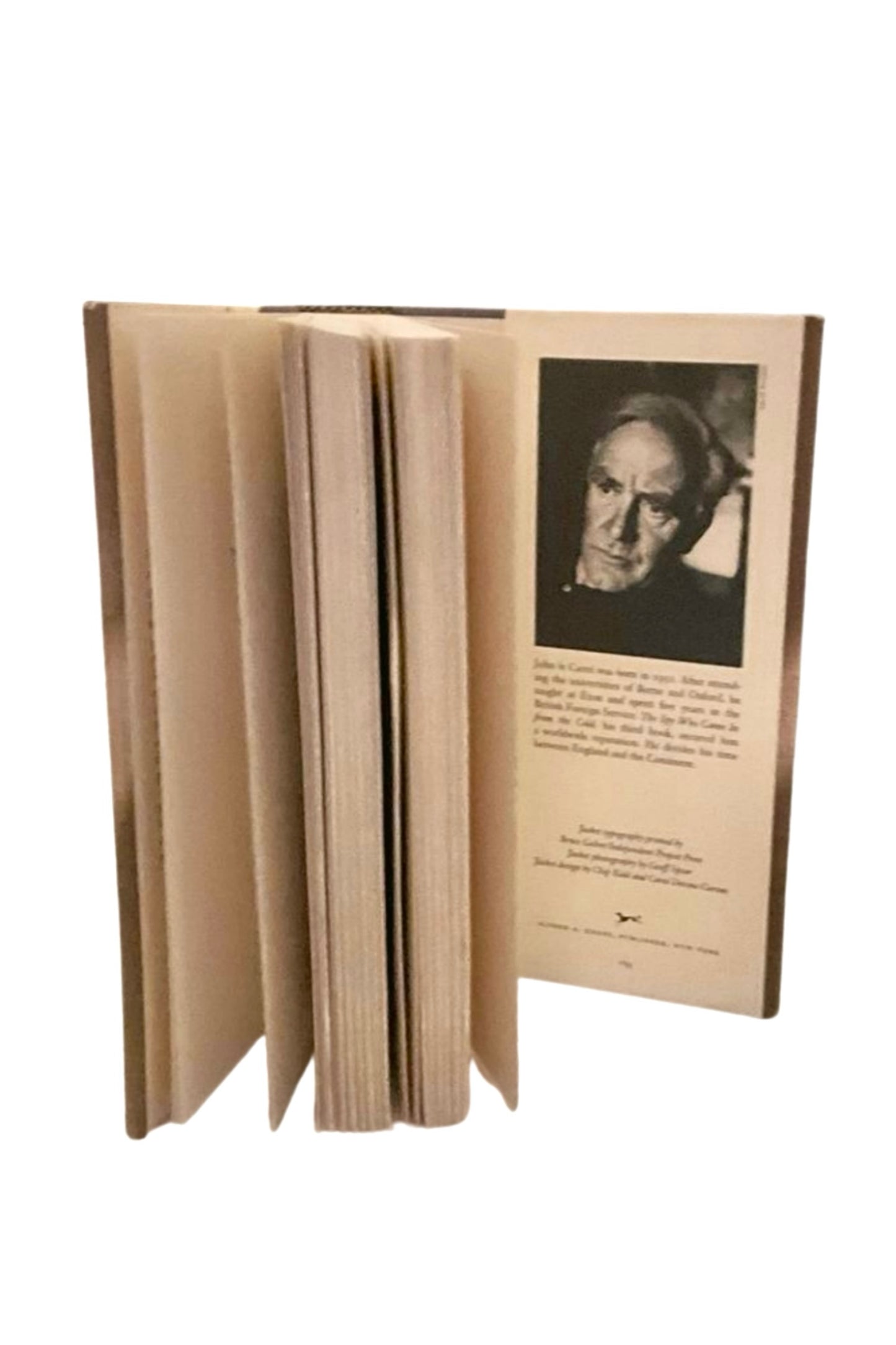 Open book showing a portrait of the author and text on a white background