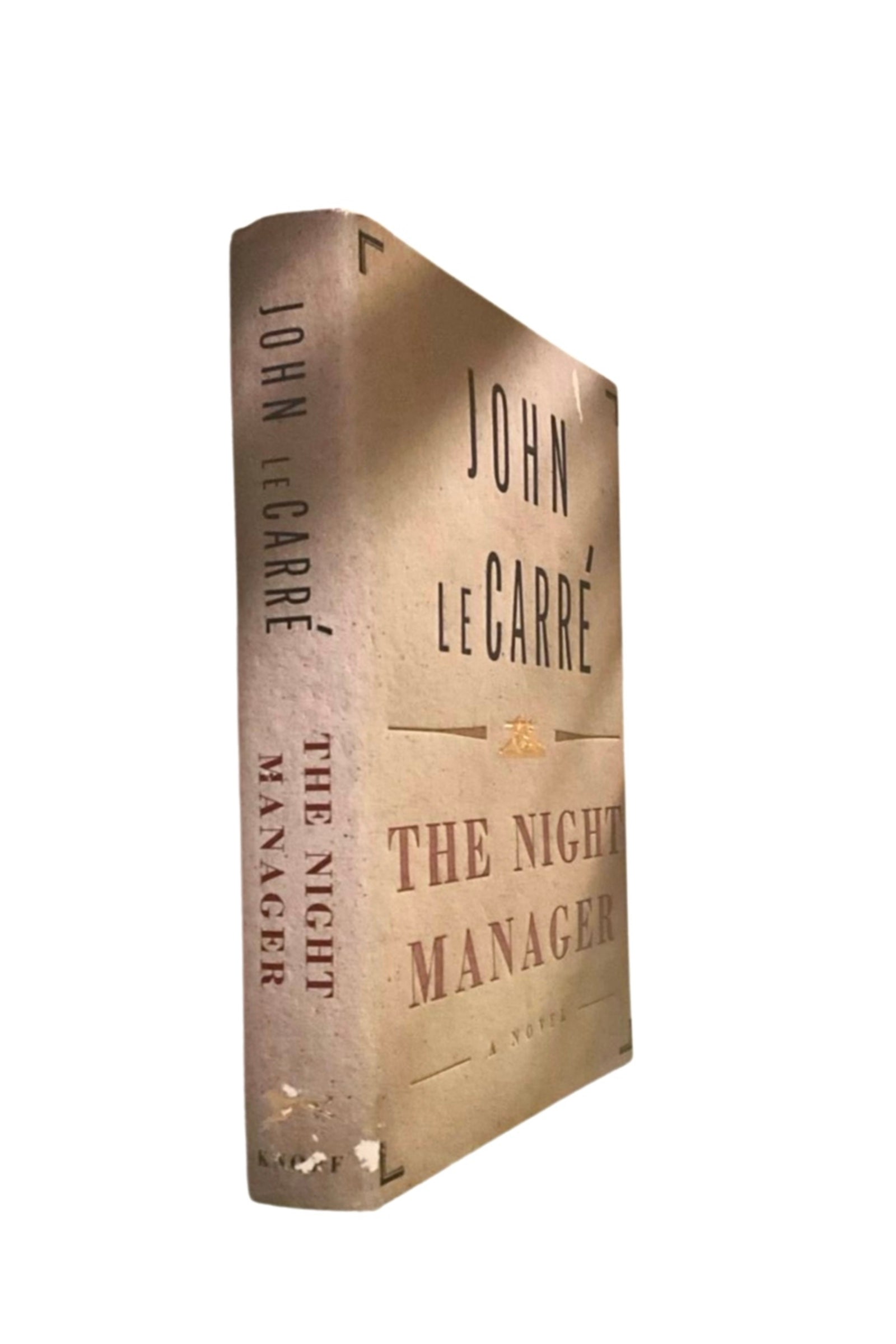 Book titled 'The Night Manager' by John le Carré , showing its spine, on a white background