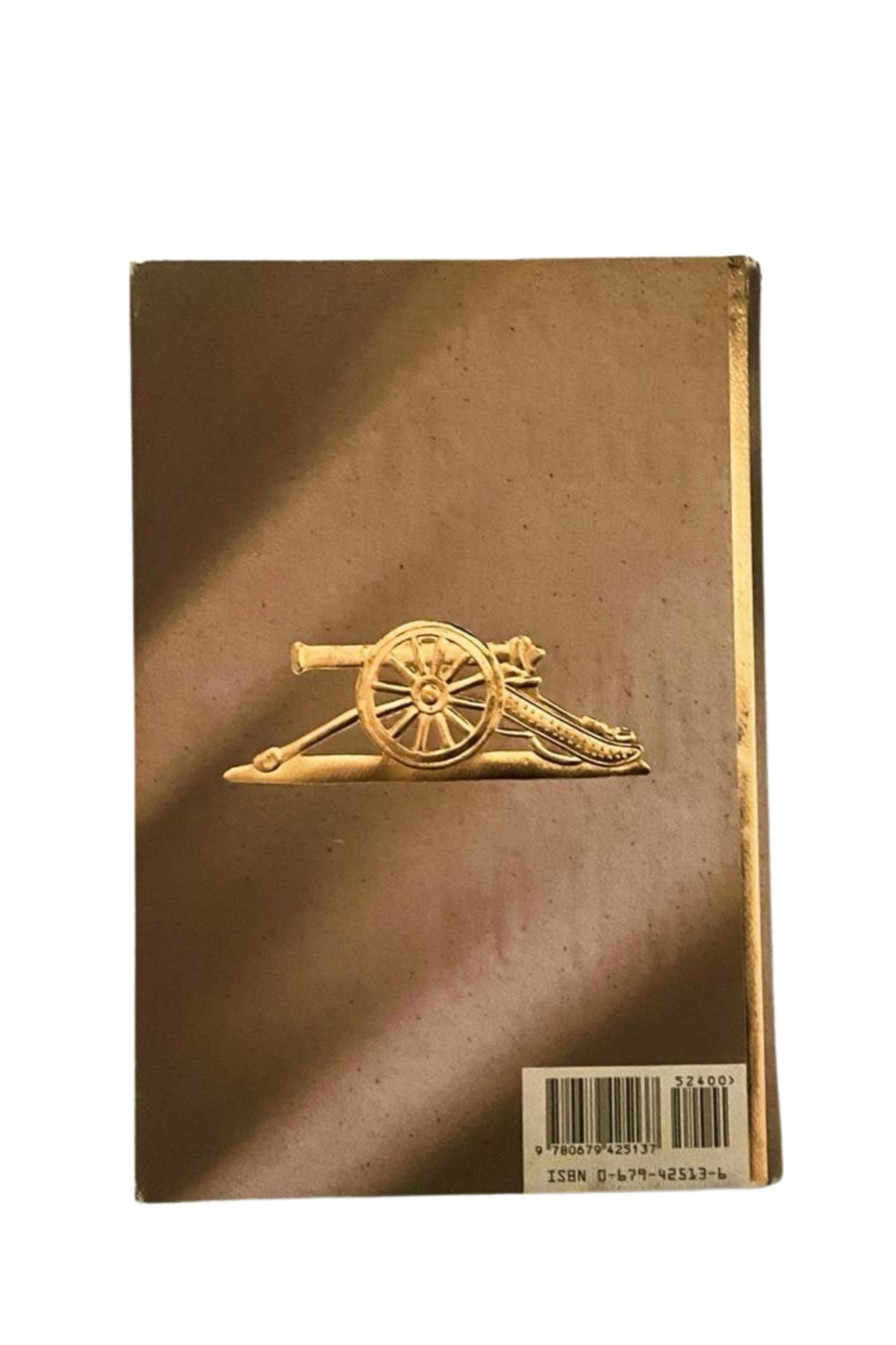 Back cover of 'The Night Manager' with a gold emblem on the cover
