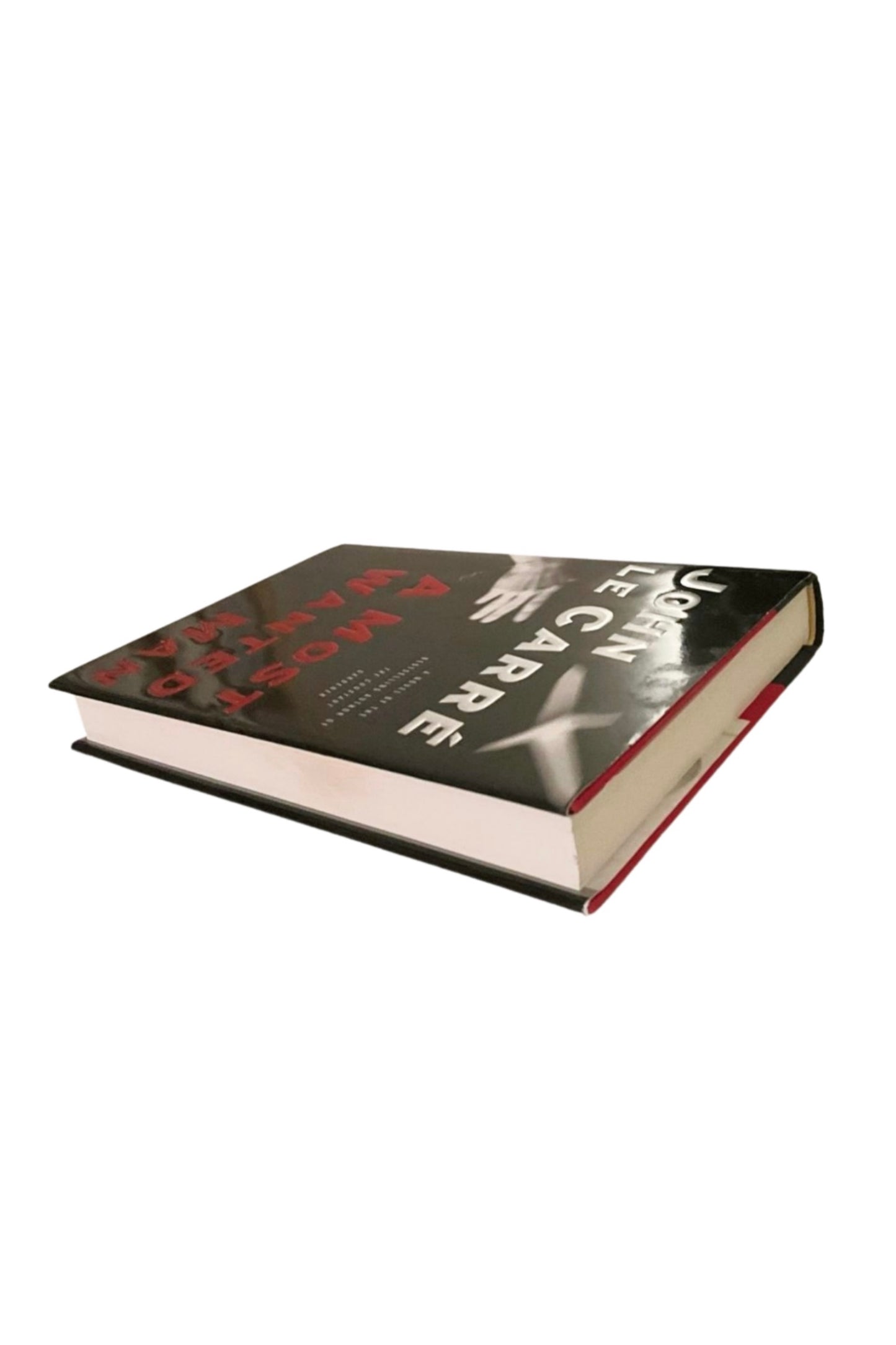 Book titled A Most Wanted Man, angled to show the edges, on a white background