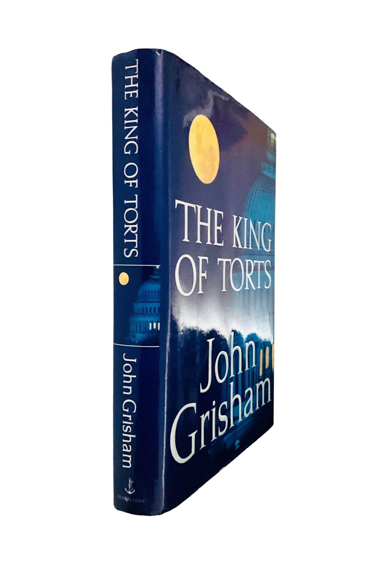 Book titled 'The King of Torts' by John Grisham on a white background, showing the front and spine