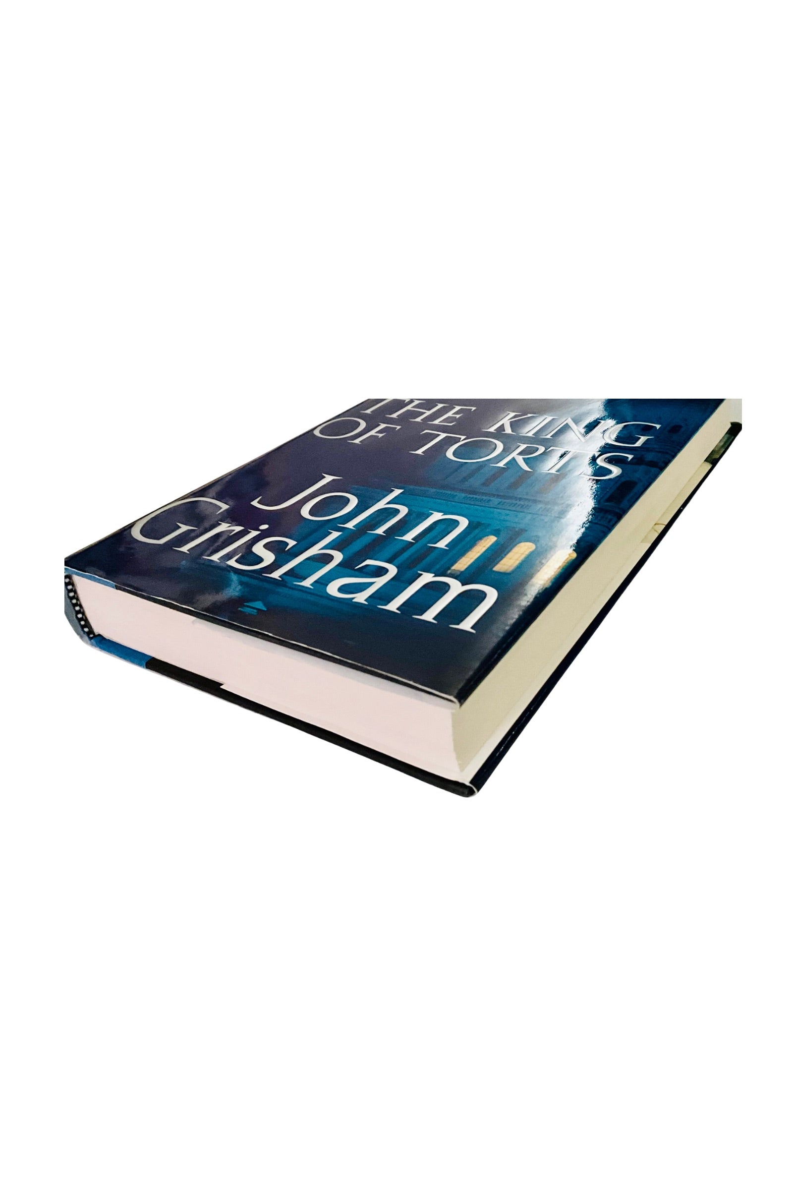 Book titled 'The King of Torts’ by John Grisham on a white background