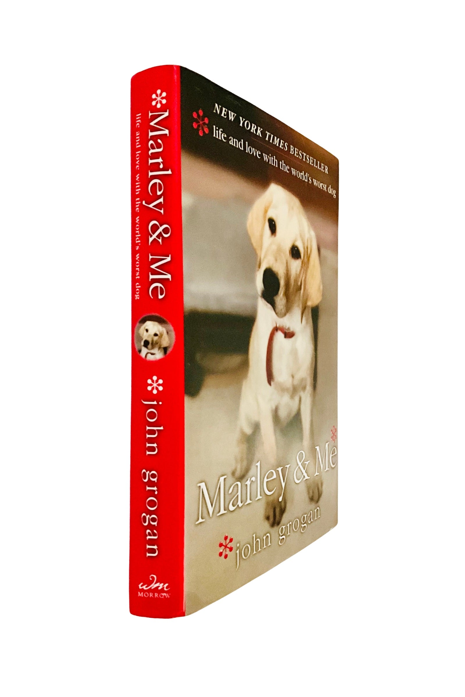 Book titled 'Marley & Me' by John Grogan with a dog on the cover, angled to show  the spine and front of the book