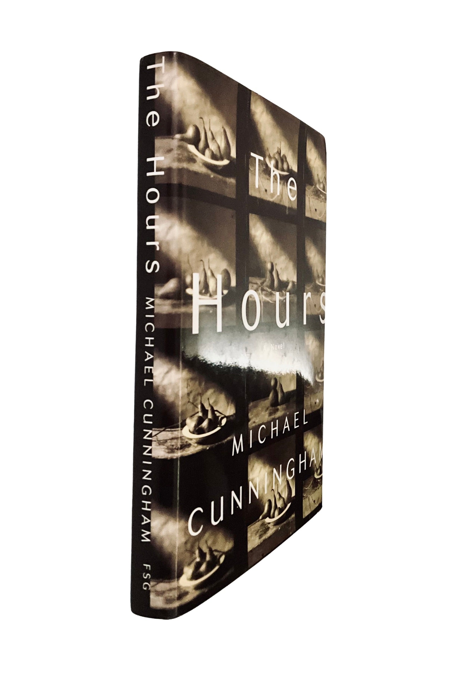 Book titled 'The Hours' by Michael Cunningham with a collage of images on the cover, angled to show the book’s spine