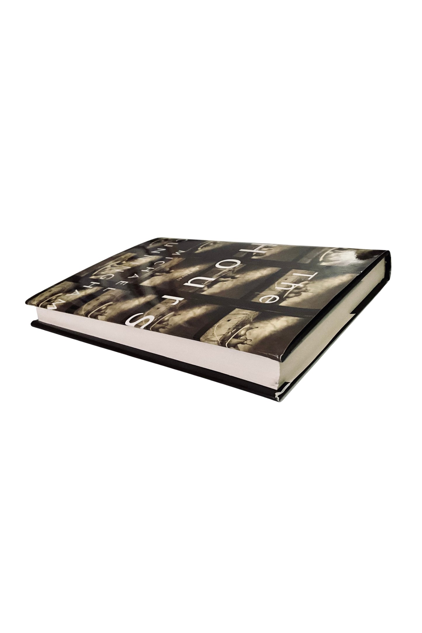 Book with a black and white cover design on a white background, angled to show the white edges