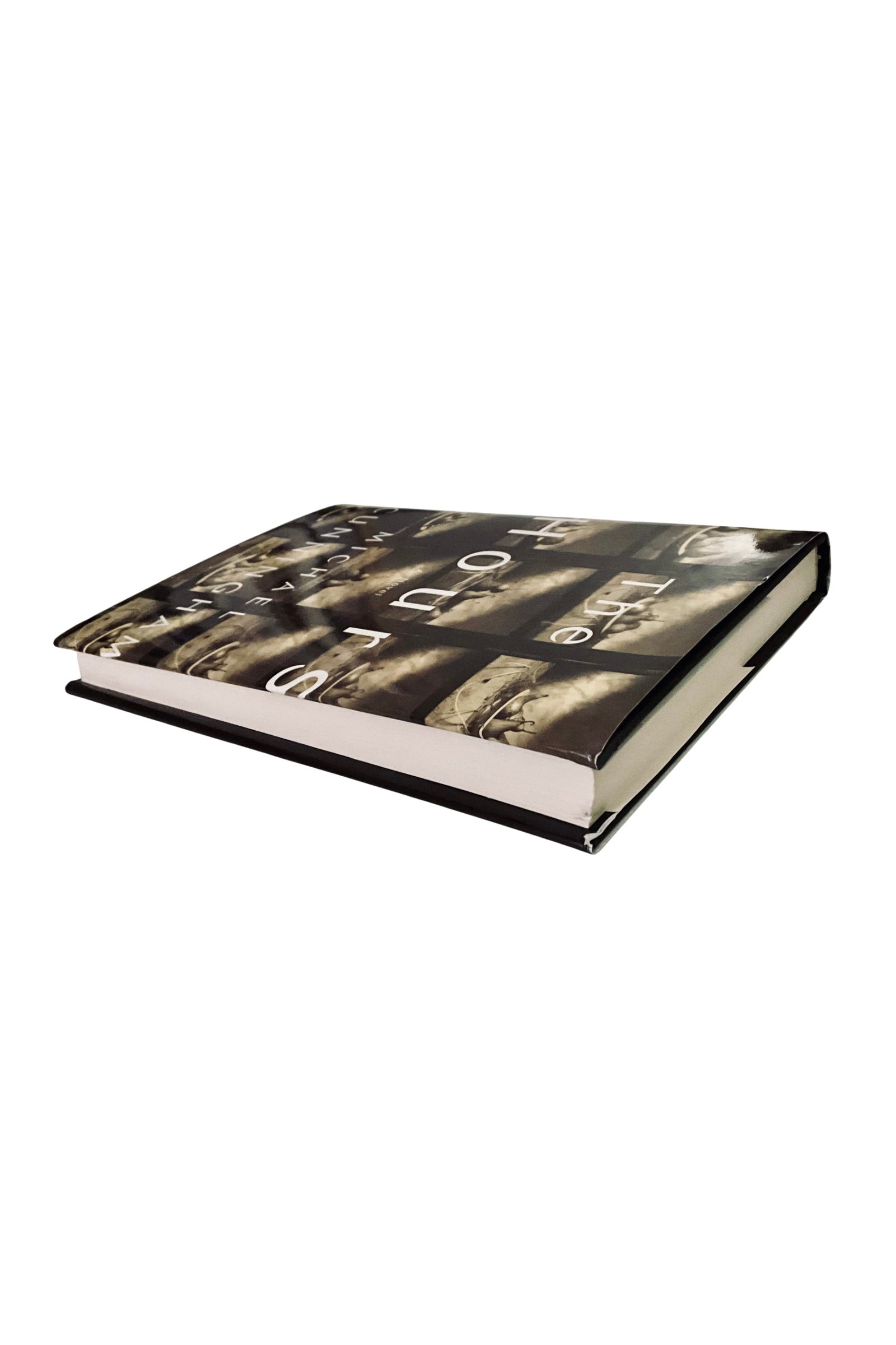 Book with a black and white cover design on a white background, angled to show the white edges
