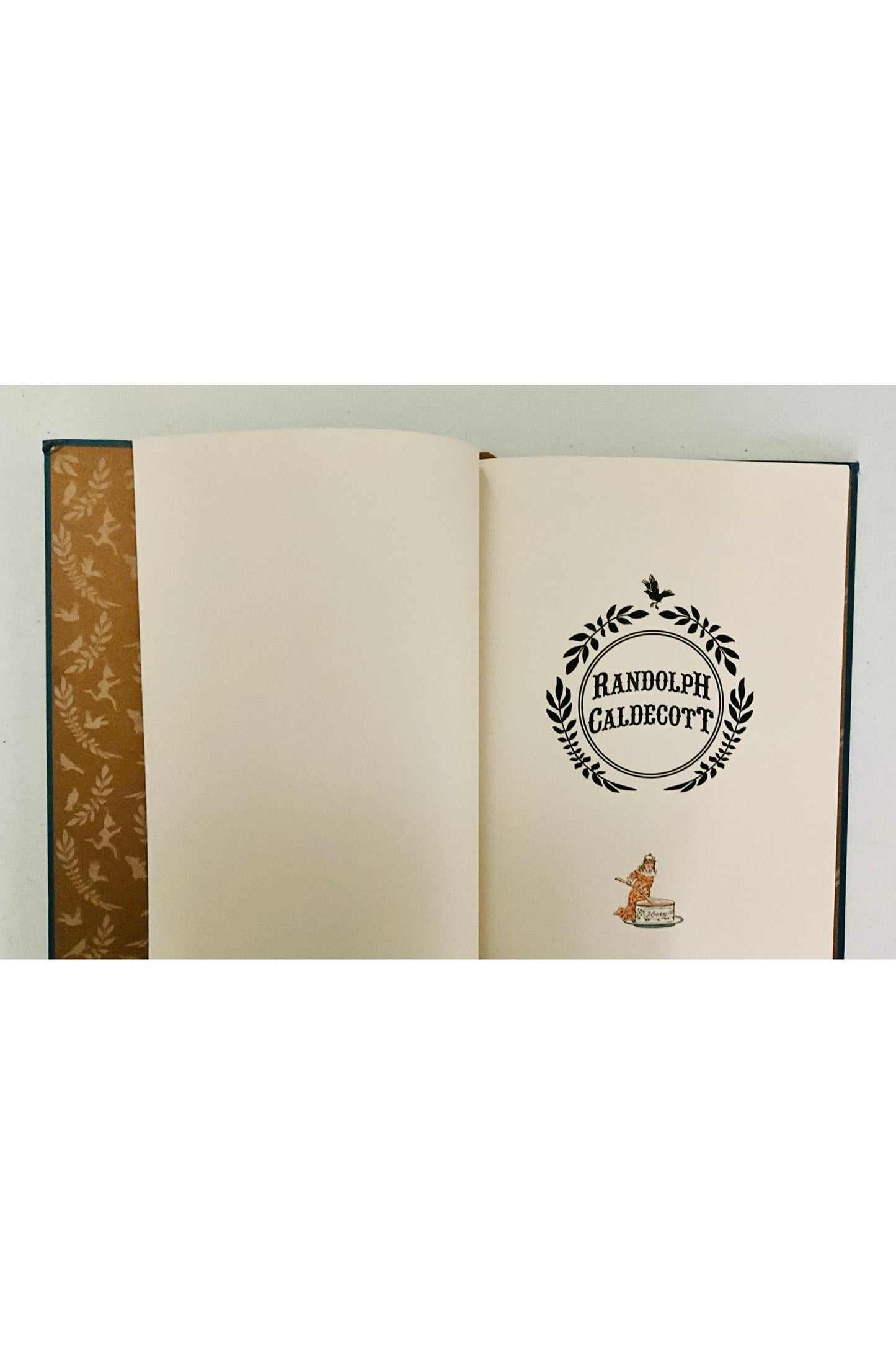 Open book with decorative inside cover  and styled title page on a white background