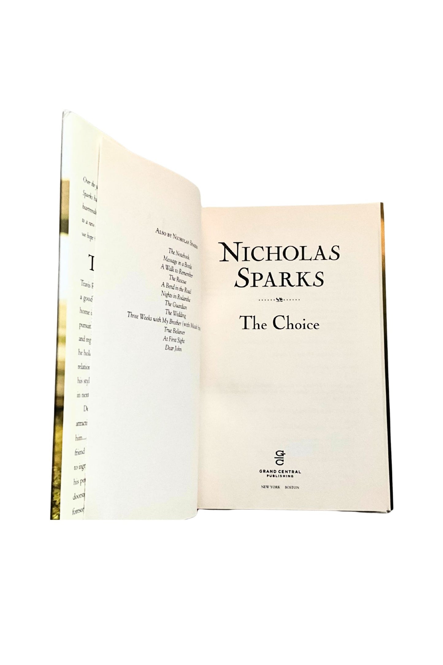 Open book titled 'The Choice' by Nicholas Sparks on a white background