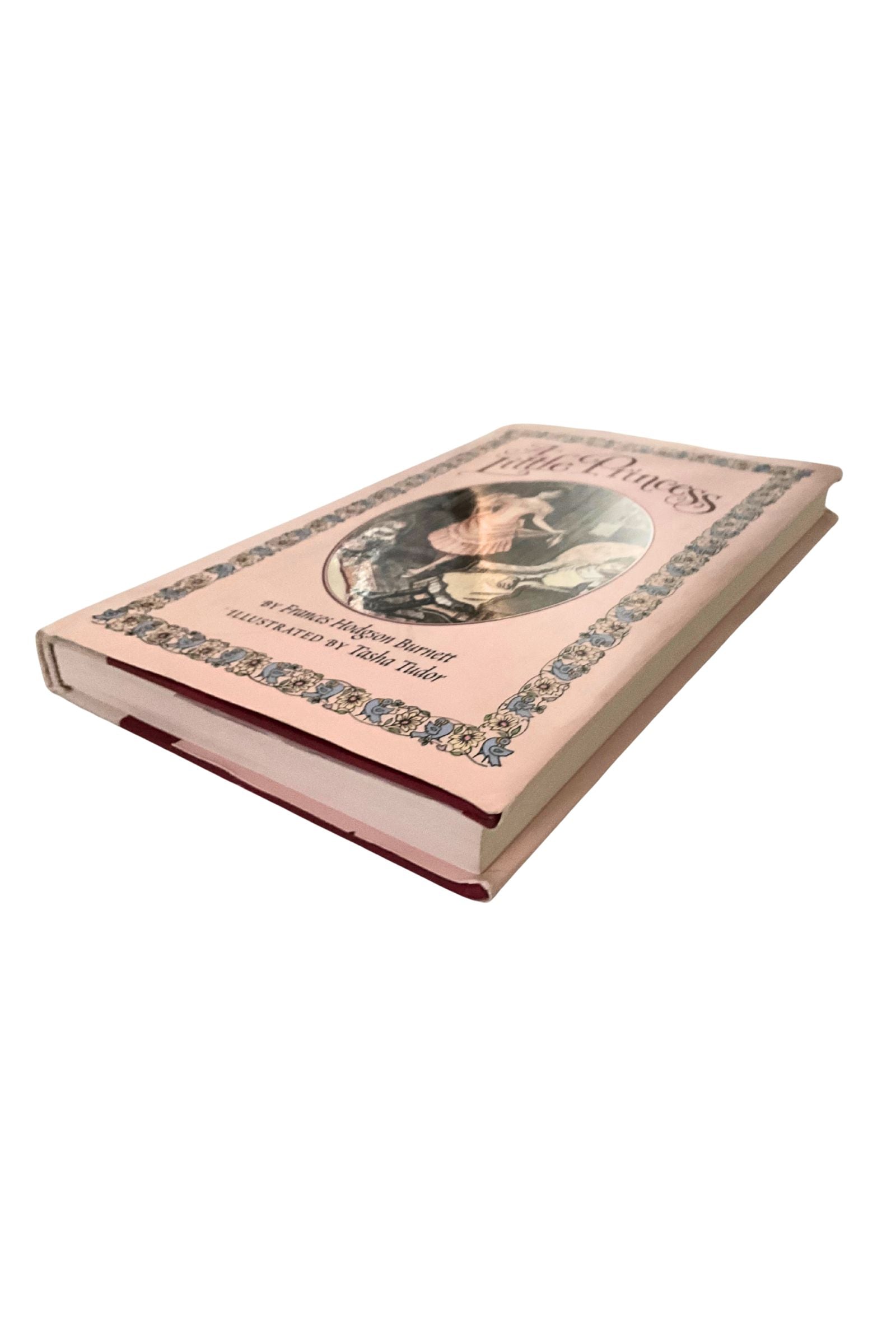 Book with decorative cover and portrait on a white background