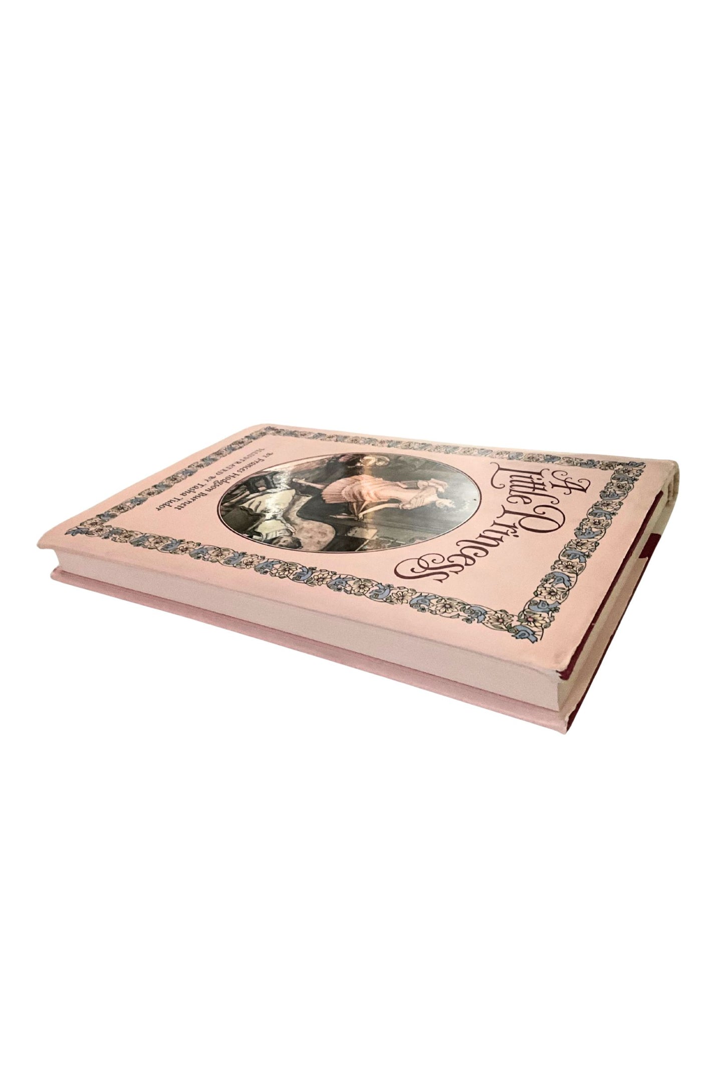 Pink book with decorative cover on a white background