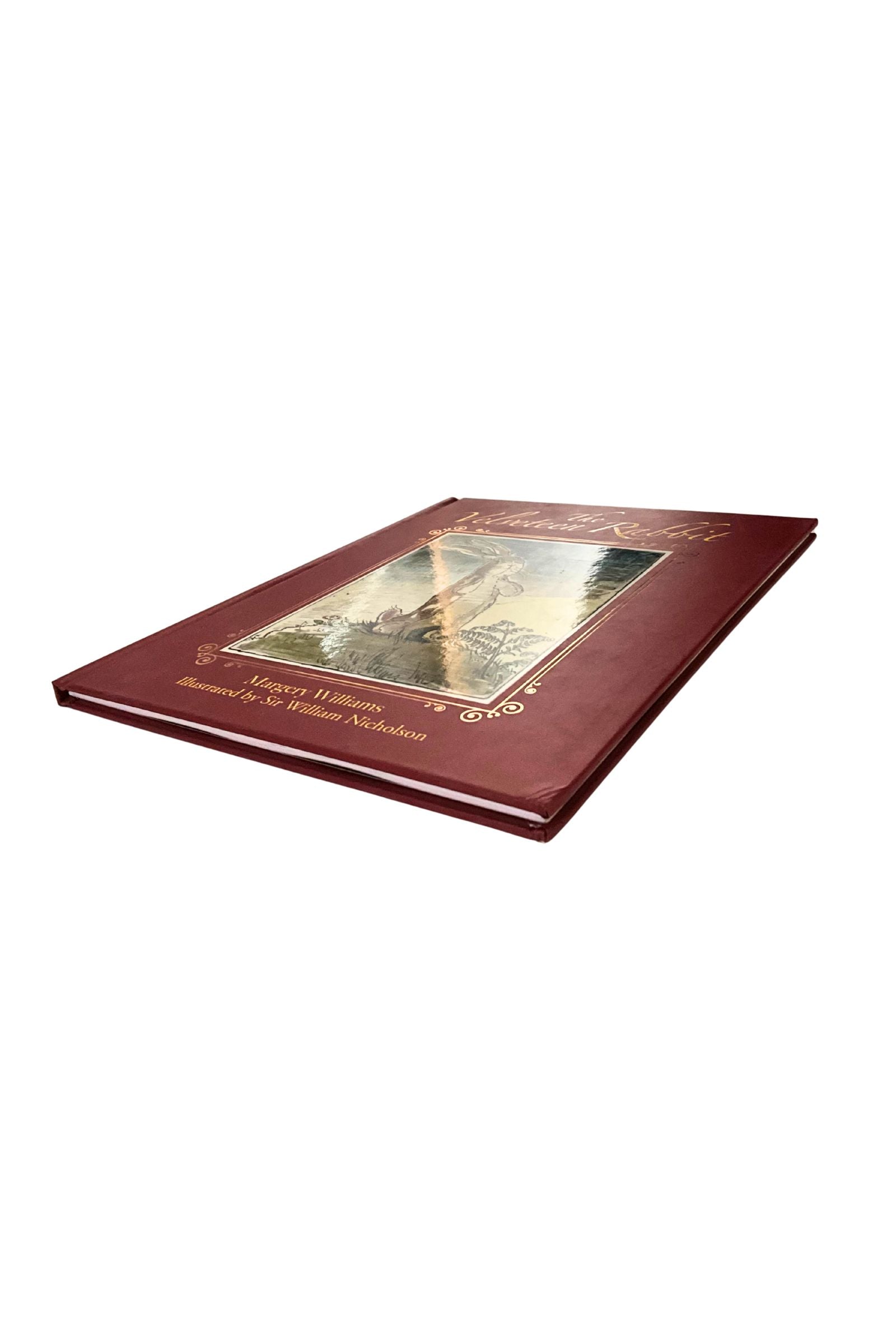 Maroon book with gold embossed cover on a white background