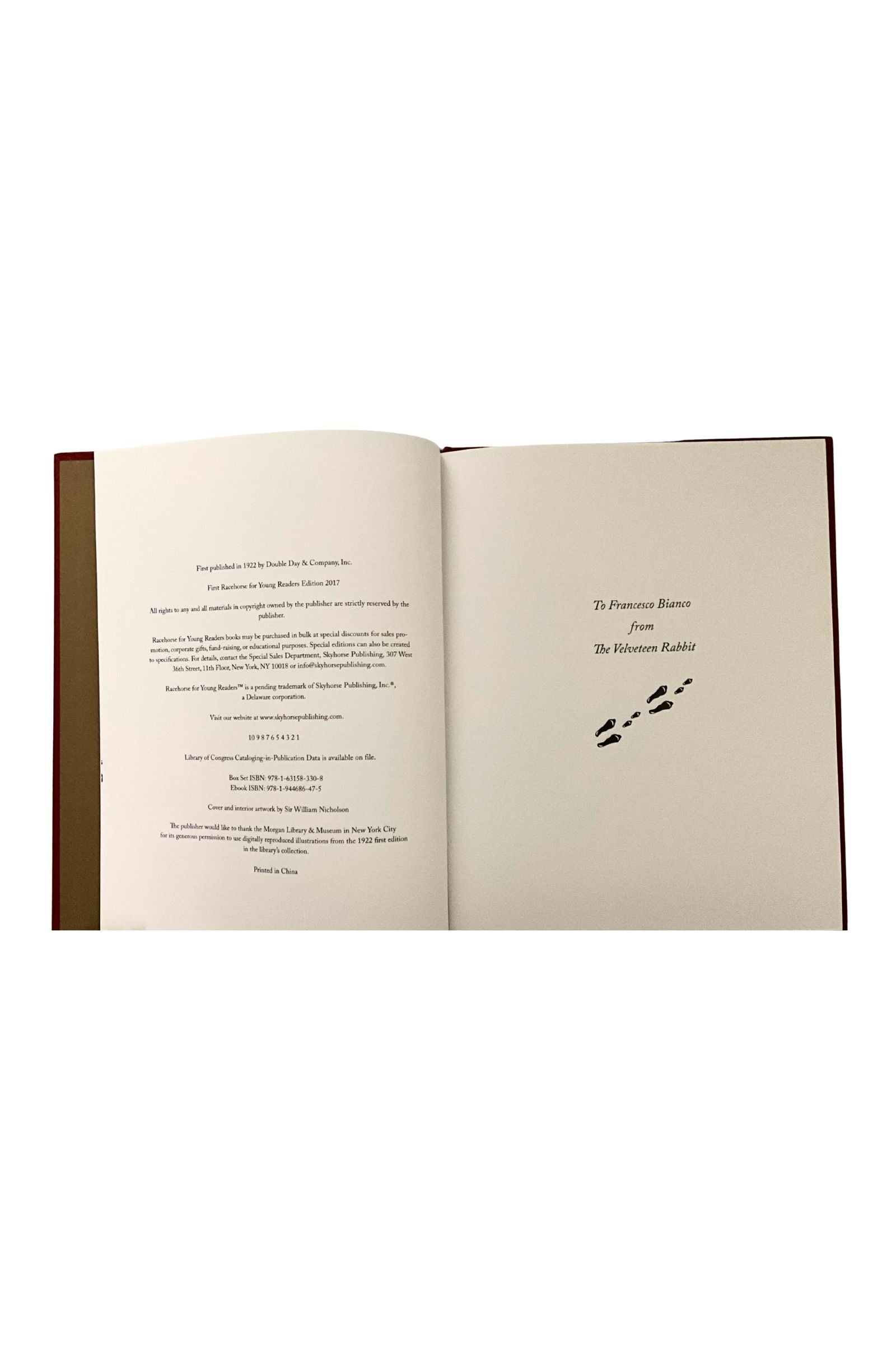 Open book with text and a small illustration on a white background