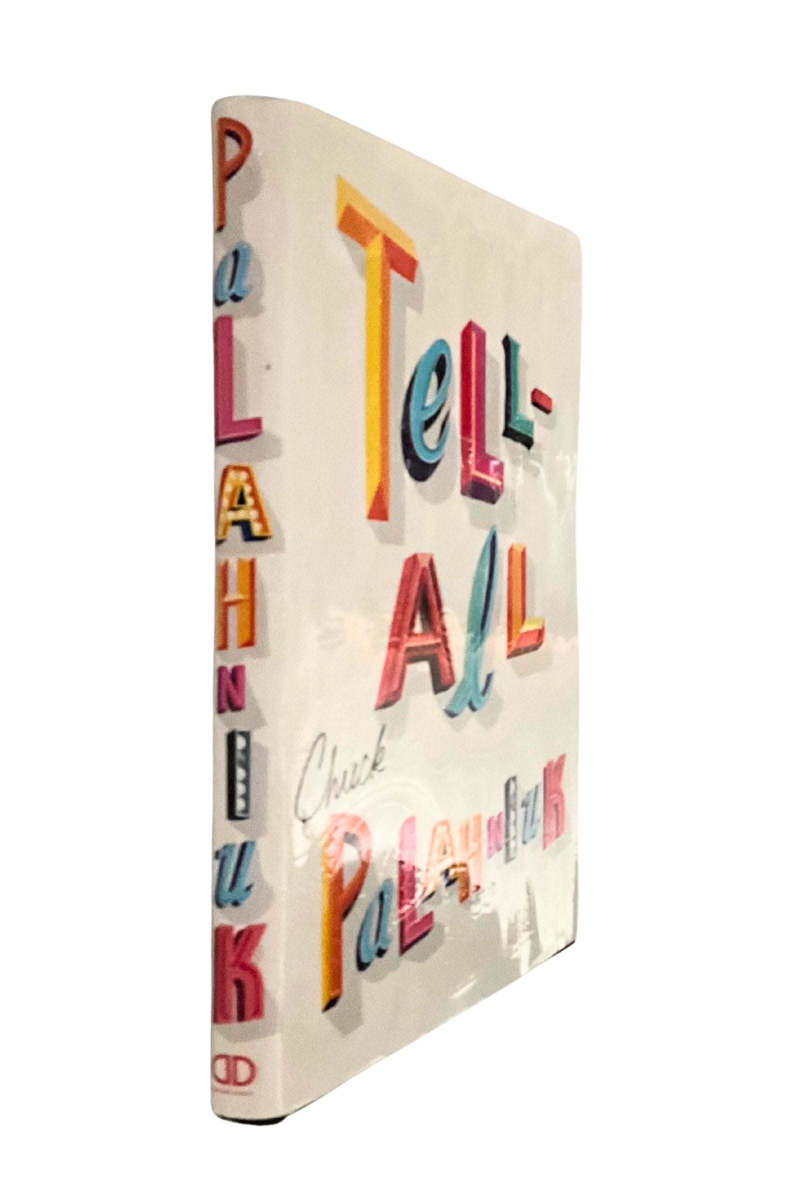 Book titled 'Tell All' with colorful text on a white background, showing the spine of the book
