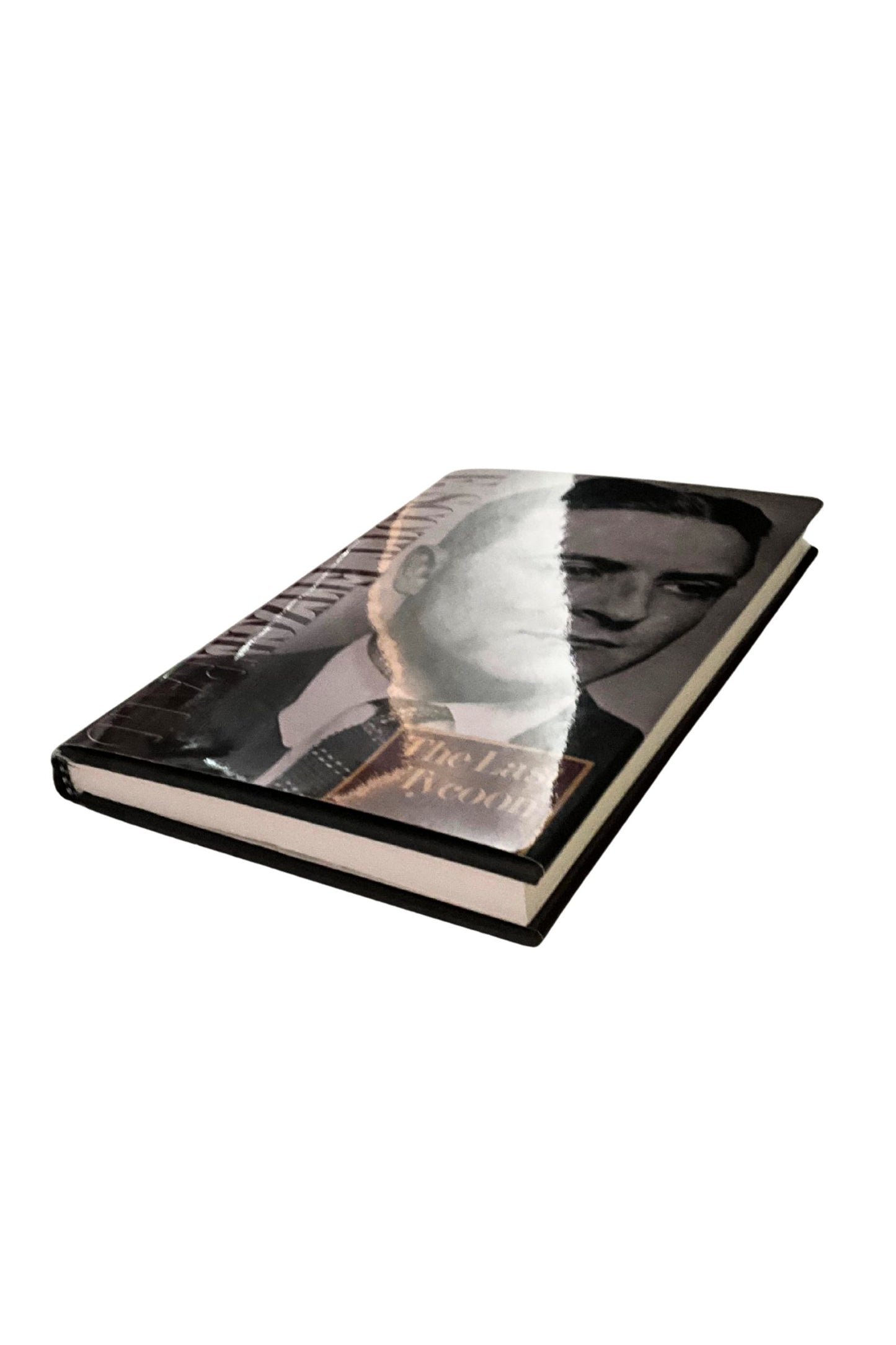 Book with a black and white portrait on the cover against a white background. The angle of the book shows the pages’ edges