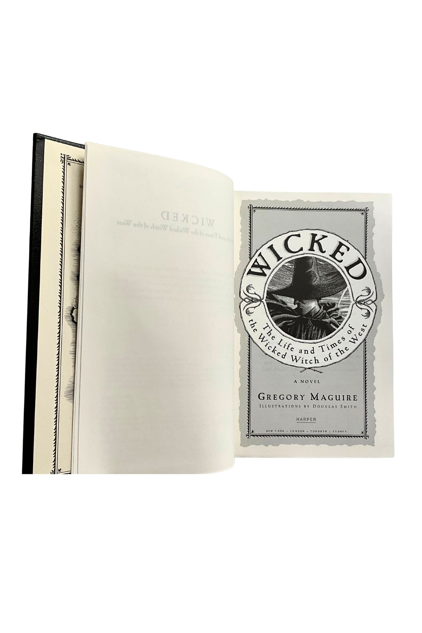 Open book with 'Wicked' by Gregory Maguire title page on a white background