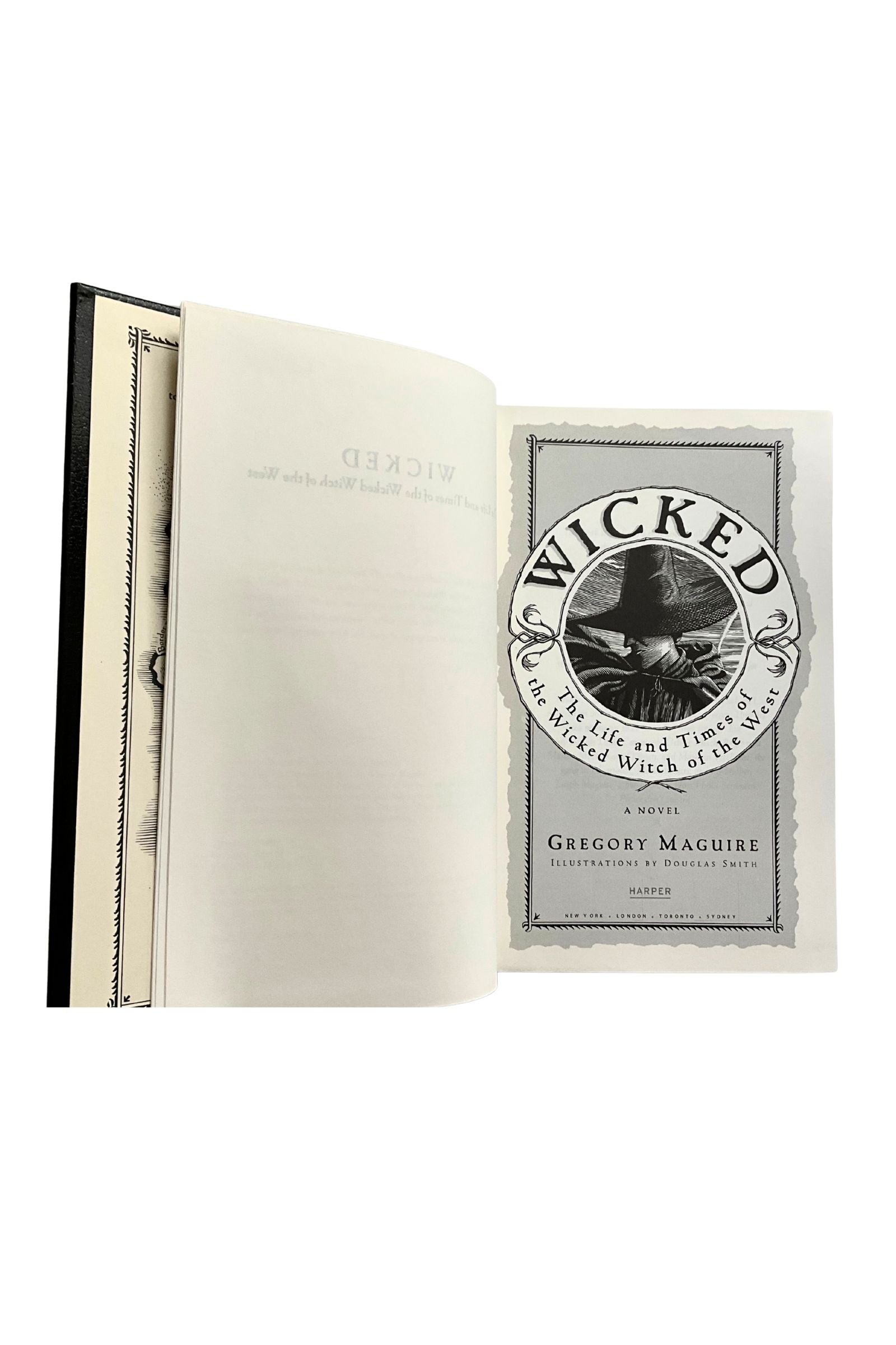 Open book with 'Wicked' by Gregory Maguire title page on a white background