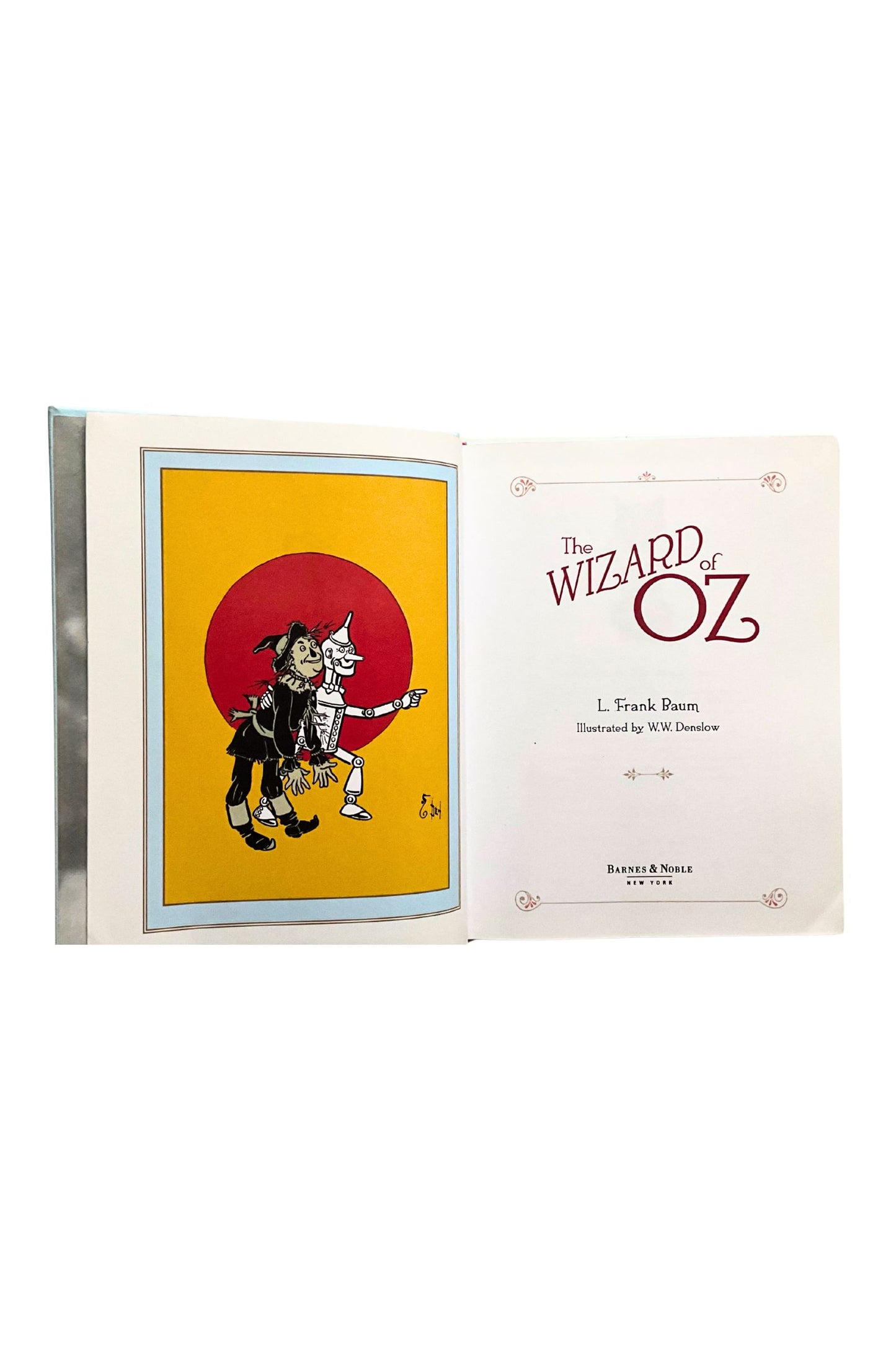 Title page of 'The Wizard of Oz' book with a red circle and character illustration on a white background