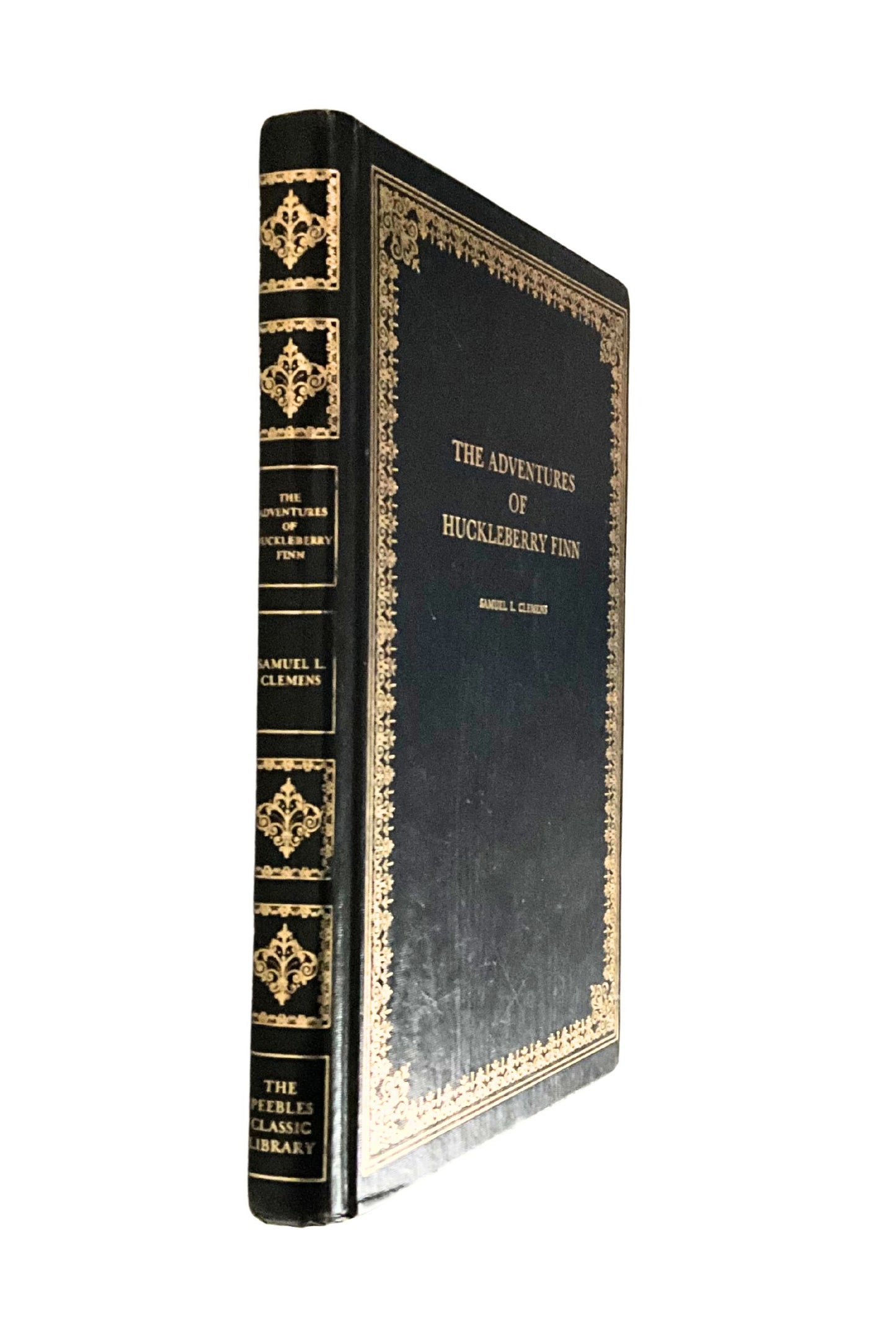 Decorative book cover of 'The Adventures of Huckleberry Finn' with gold embossed details on a white background