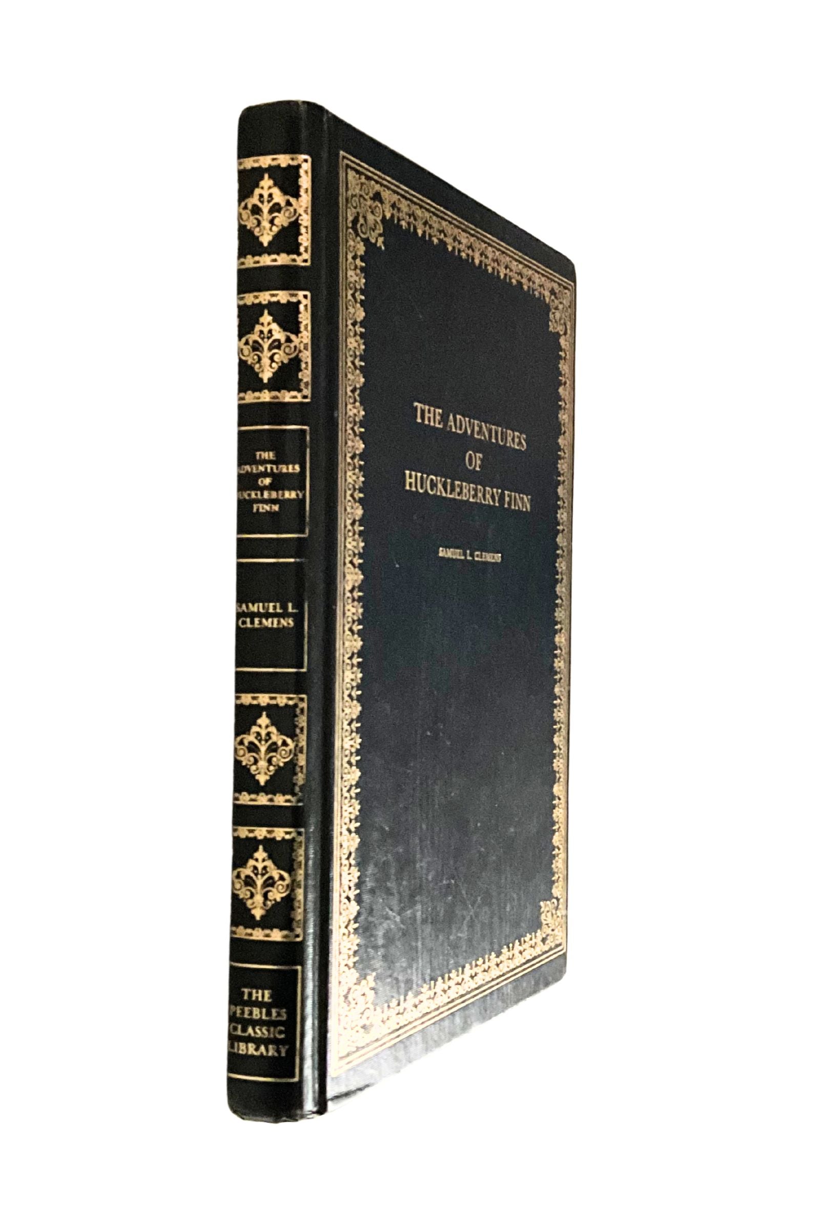 Decorative book cover of 'The Adventures of Huckleberry Finn' with gold embossed details on a white background