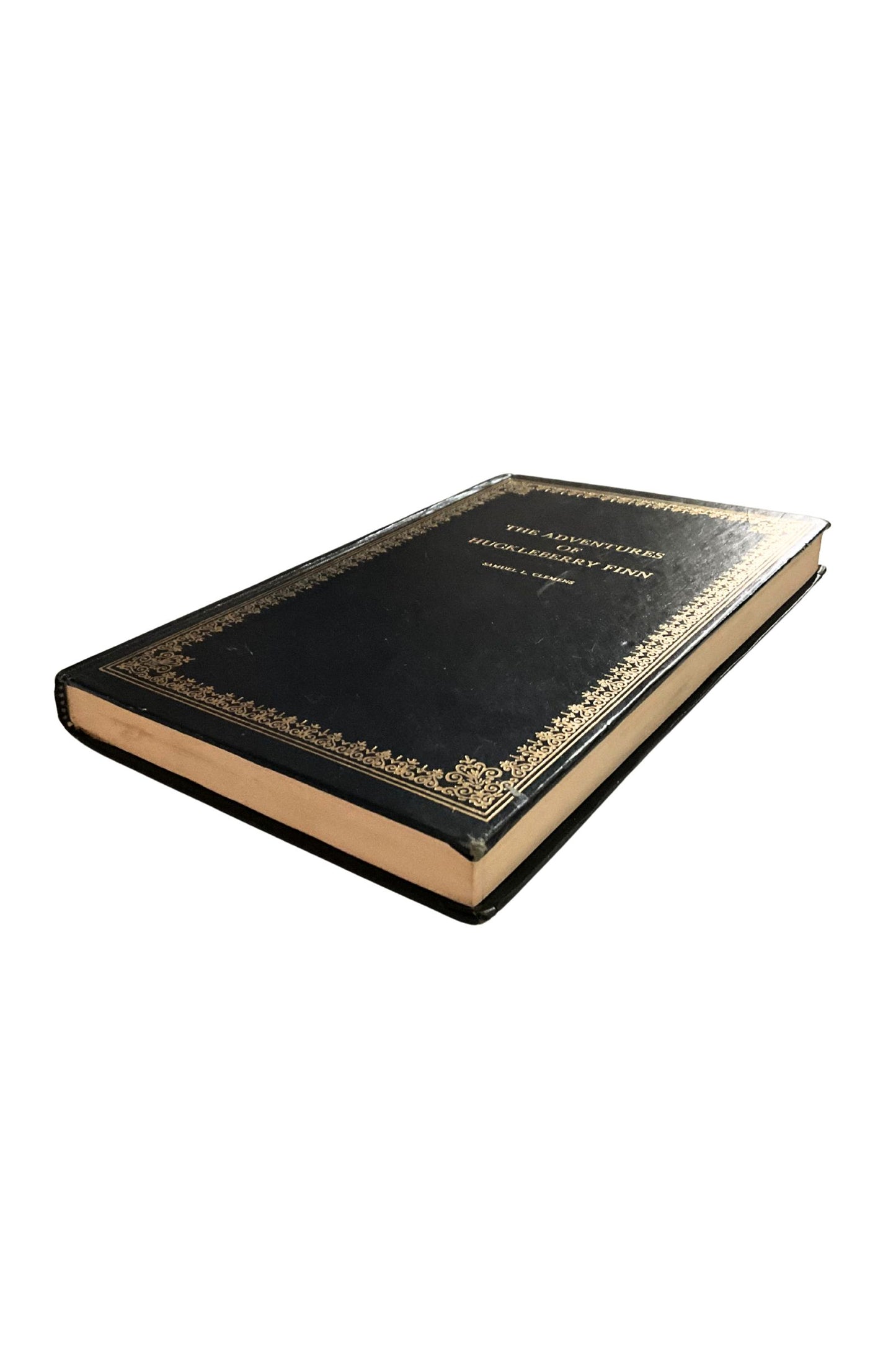 Black leather-bound book with gold embossed design on a white background