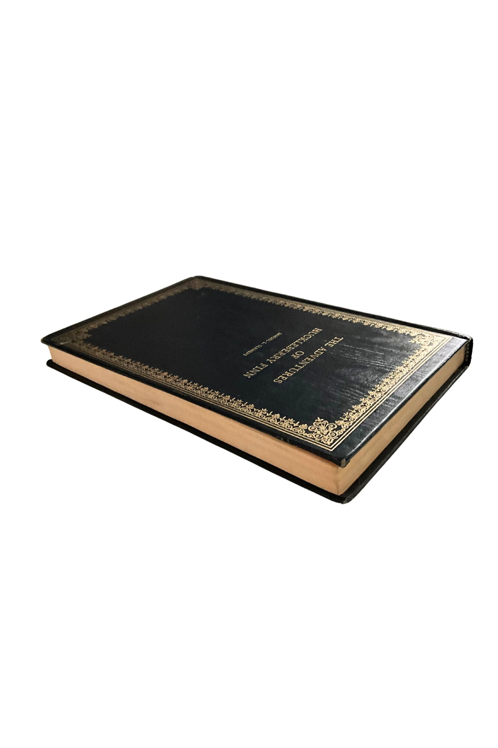 Decorative black book with gold embossed text on a white background