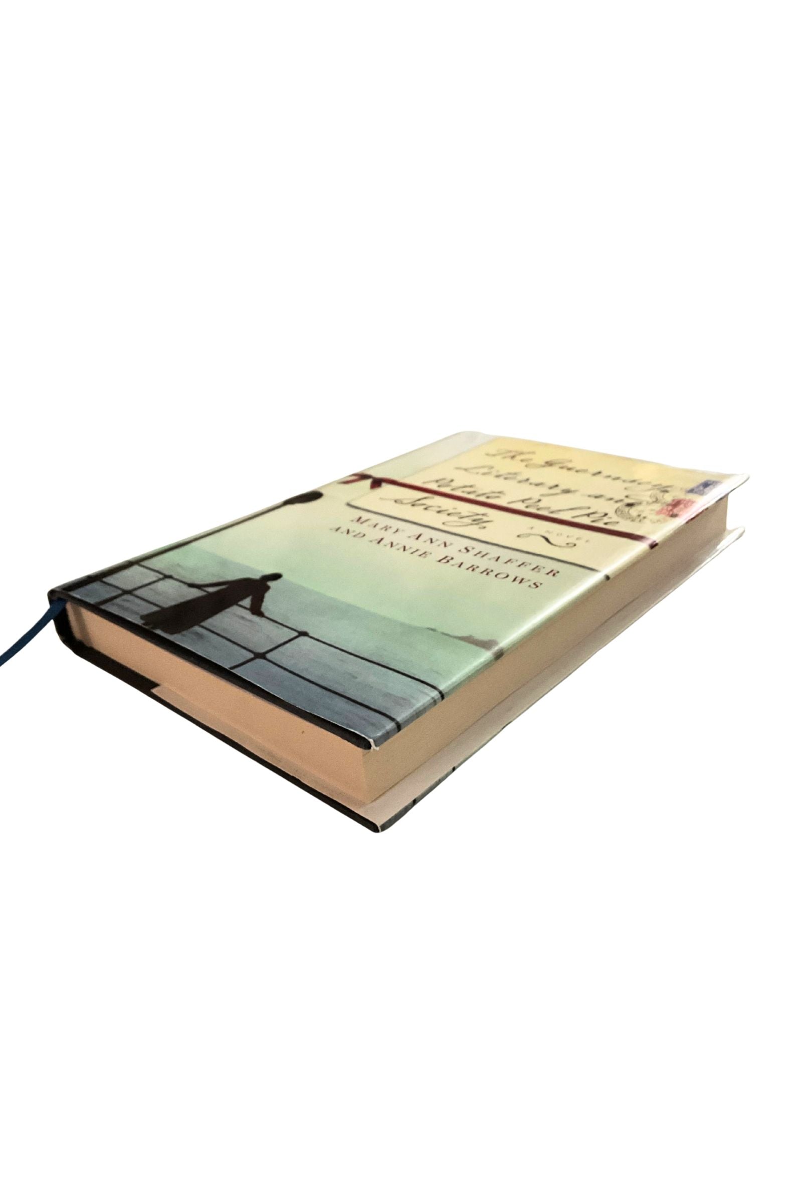 Book with a cover featuring a silhouette of a person on a bridge over water, on a white background.