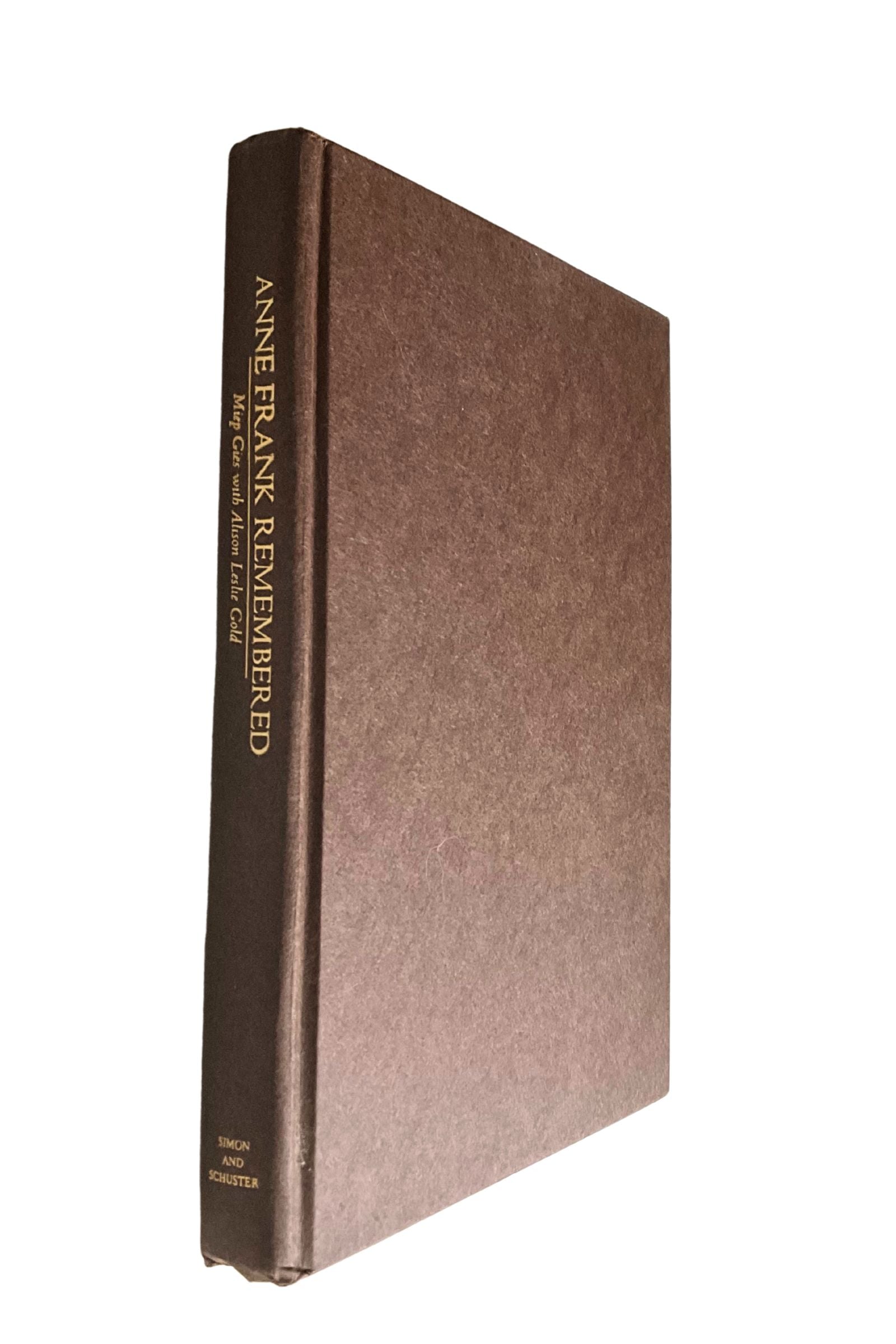 Brown book titled 'Anne Frank Remembered' on a white background