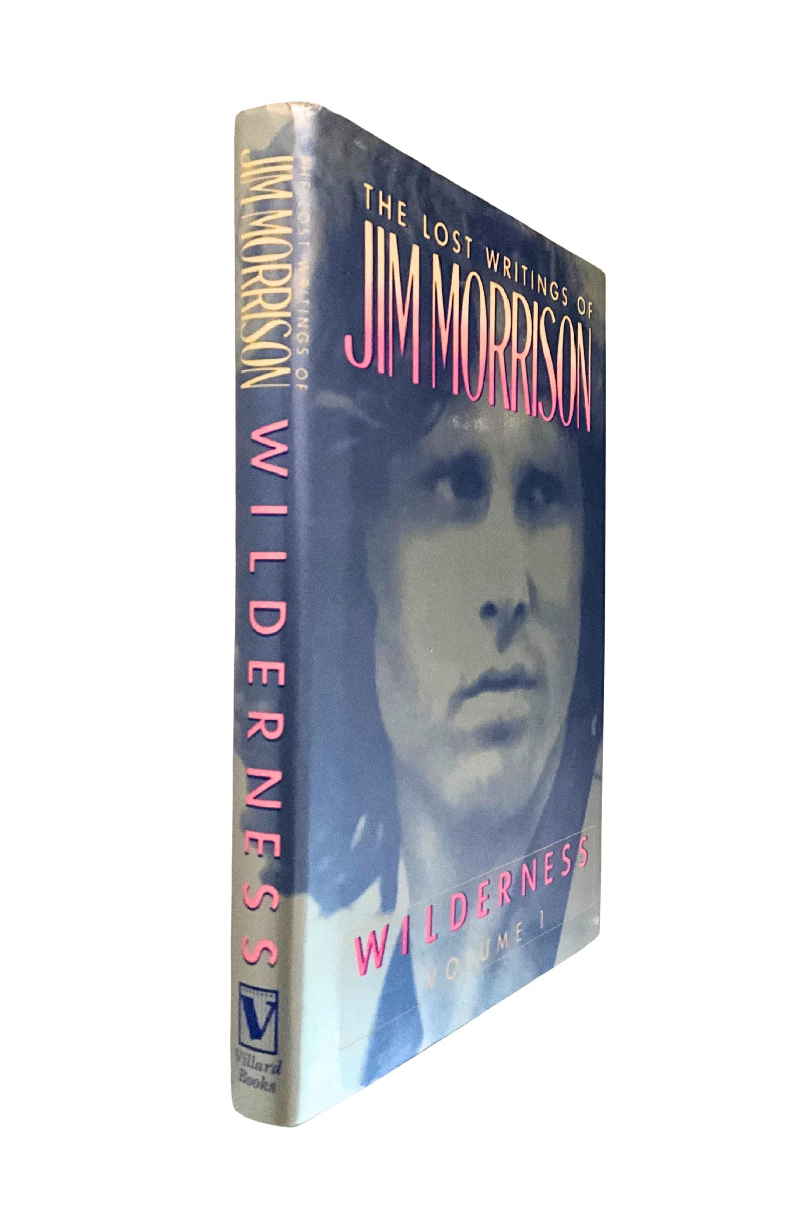Book titled 'Wilderness: The Lost Writings of Jim Morrison' with a portrait on the cover, angled to show the spine and front cover