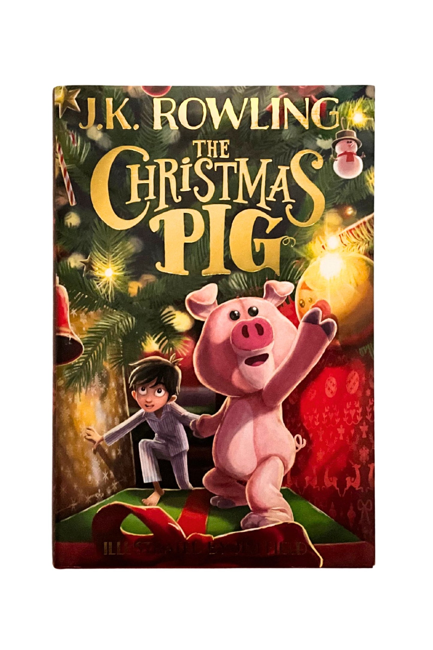 Book cover of 'The Christmas Pig' by J.K. Rowling with a pig and child illustration.