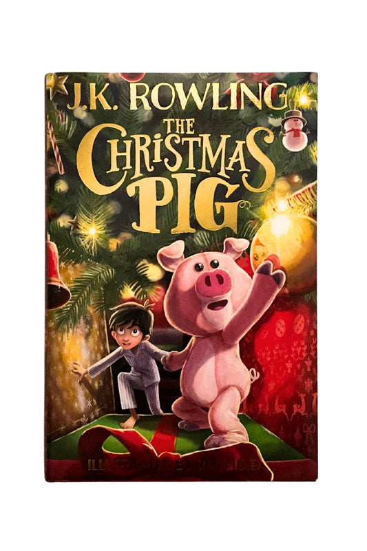 Book cover of 'The Christmas Pig' by J.K. Rowling with a pig and child illustration.