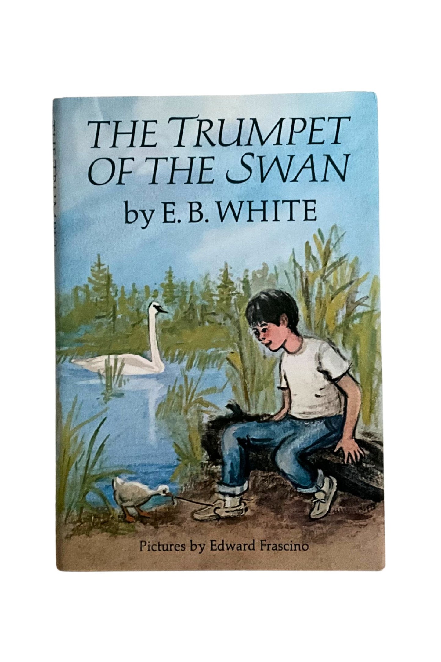 Book cover of 'The Trumpet of the Swan' by E.B. White with illustration of a boy and swan.