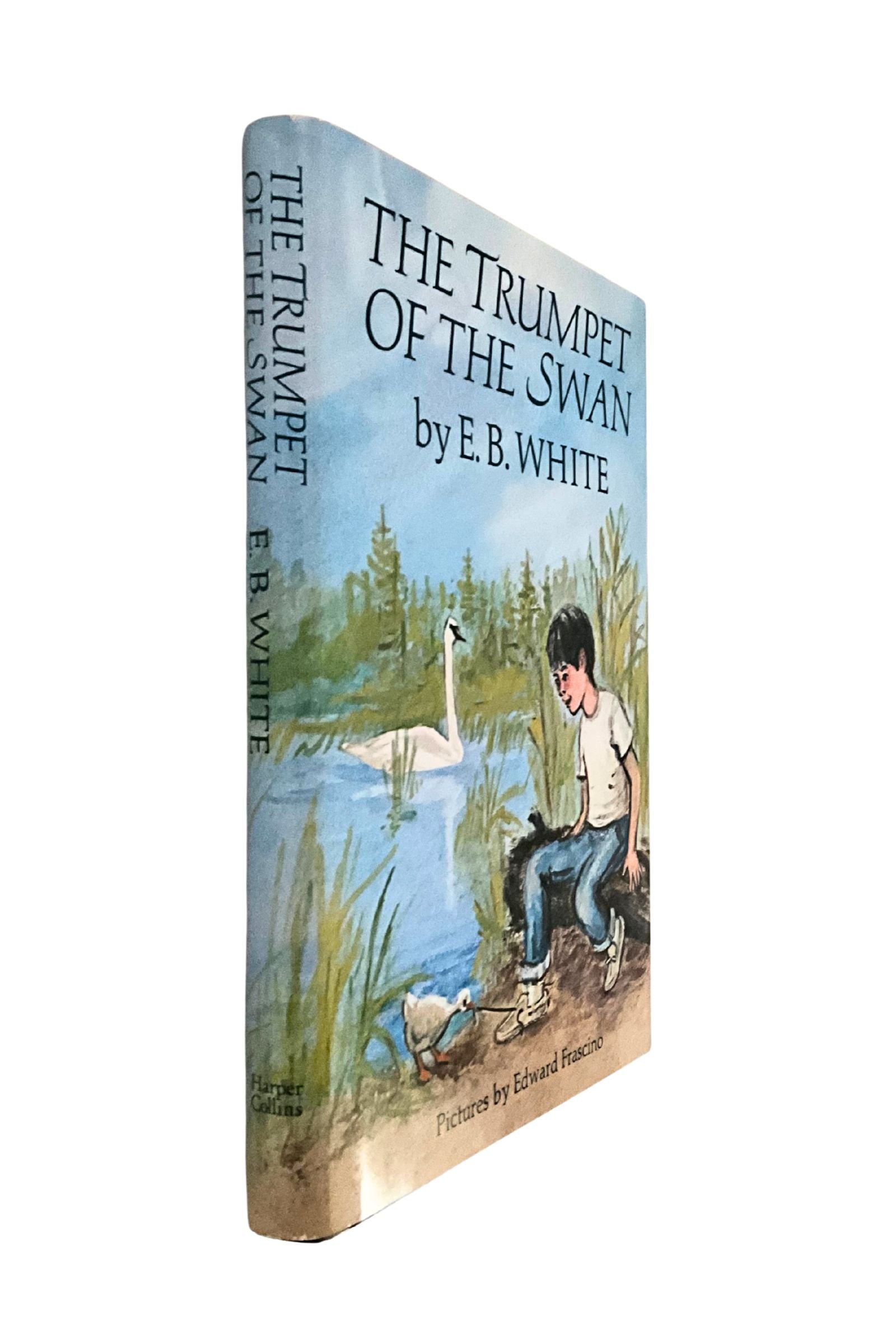 Book cover of 'The Trumpet of the Swan' by E.B. White with a boy and swan illustration, shown sideways