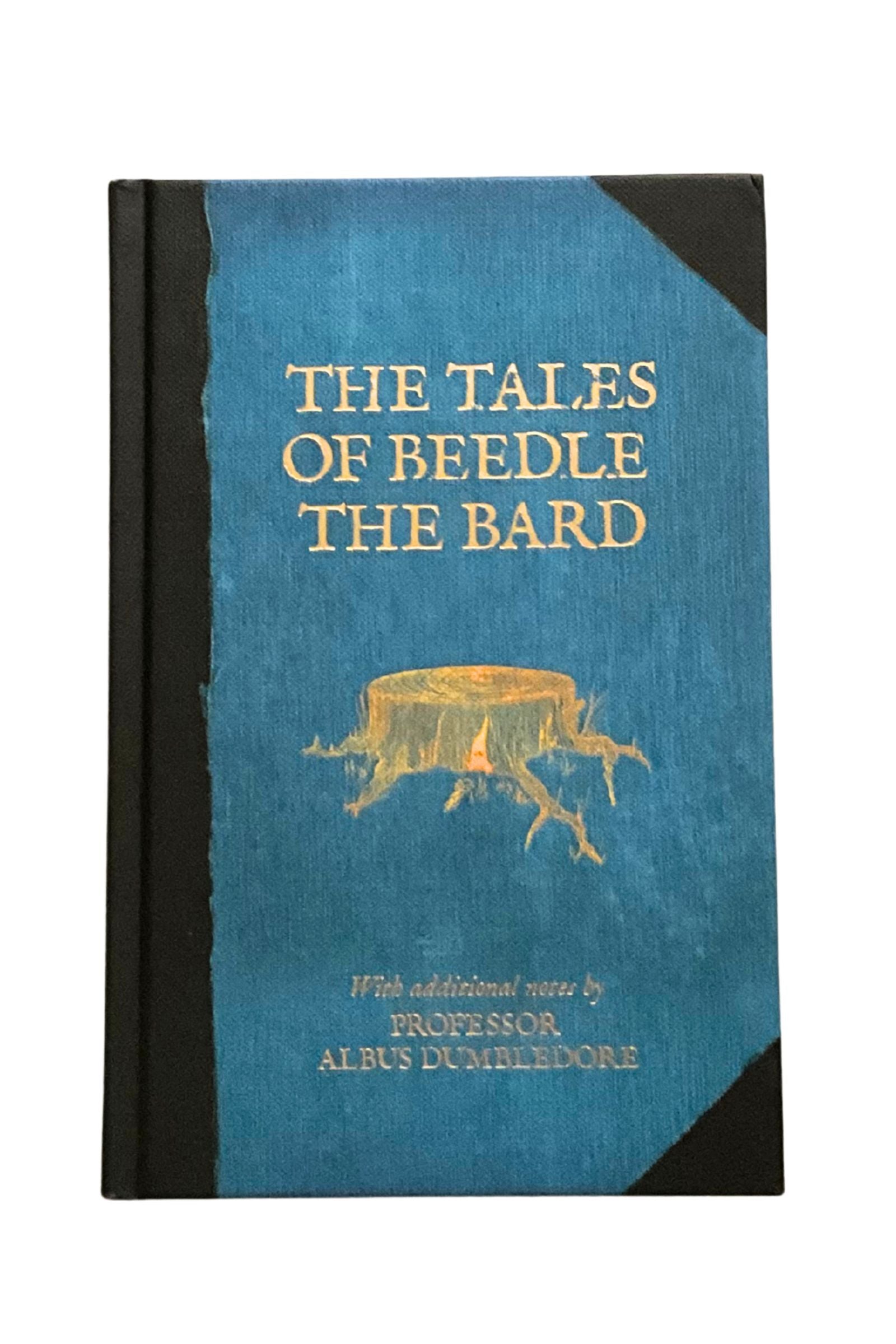 Book titled 'The Tales of Beedle the Bard' with a blue cover and black spine on a white background
