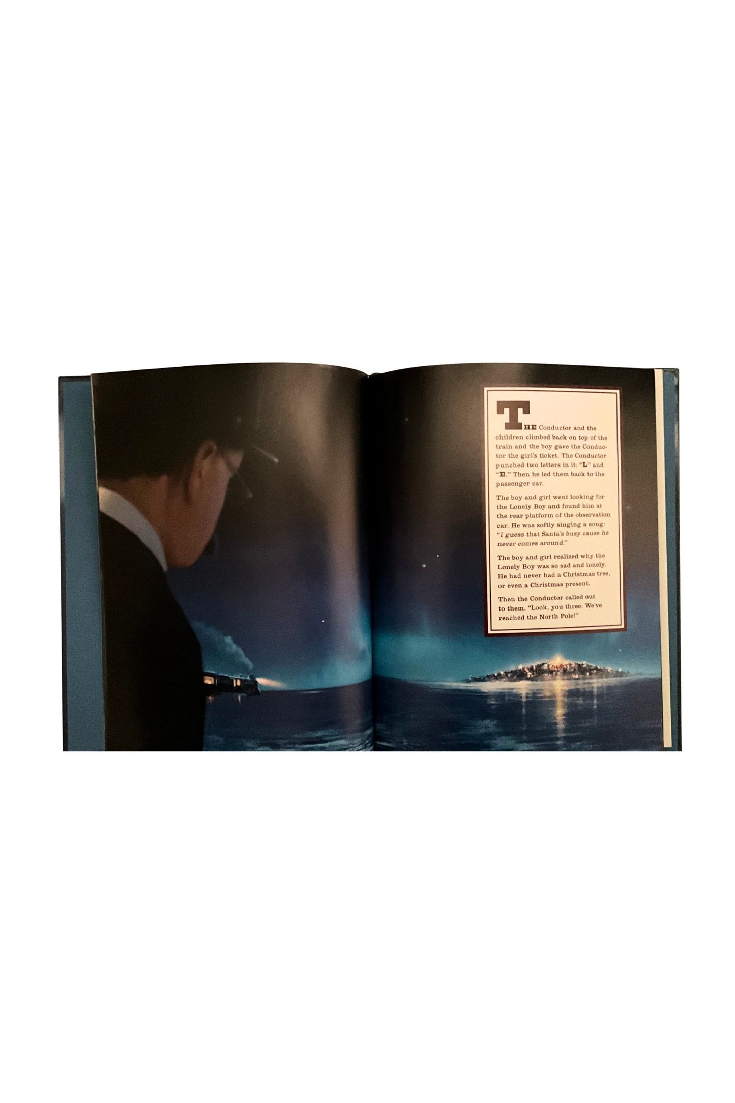 Open book showing a page with text and an image of a conductor  looking out of a train at a winter nighttime landscape