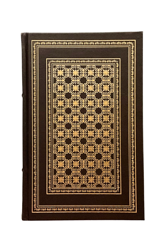 Decorative book with intricate gold pattern on a white background