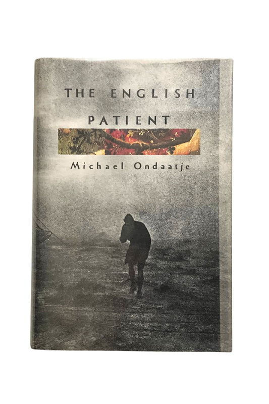 Book cover of 'The English Patient' by Michael Ondaatje with a silhouette of a person walking on a misty landscape.