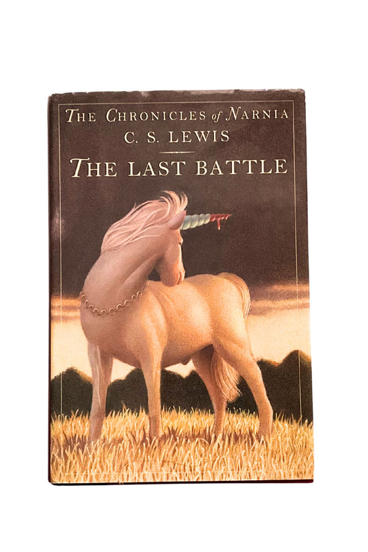 Book cover of ‘The Last Battle’, a book by C.S. Lewis, showing a unicorn standing on a grassy landscape.