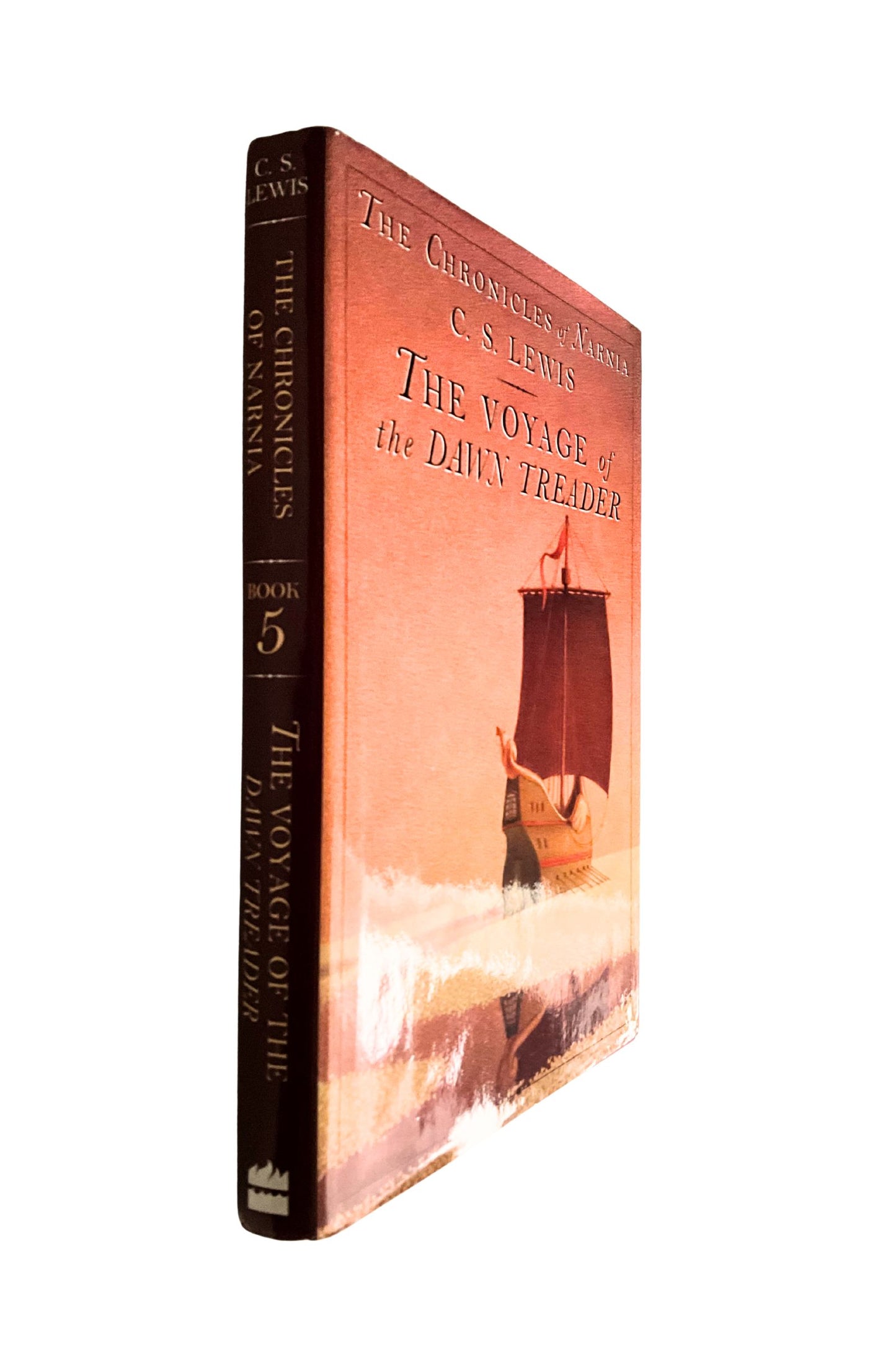 Book titled 'The Voyage of the Dawn Treader' by C.S. Lewis on a white background, shown at  an angle